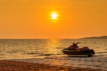 Obraz premium Jet ski parked on a beach with beautiful landscape sunset