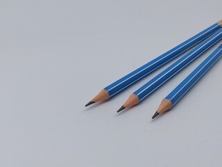 Close-up of blue pencils against white background