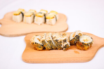delicious sushi and a pair of chopsticks isolated on white background