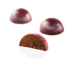 Handmade chocolate candies with filling isolated on a white background.