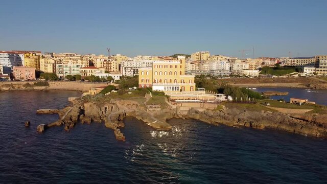 Colourful seafront houses in the historic town of Alghero, Italy. Aerial view