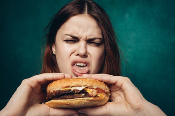 woman eating hamburger fast food snack close-up