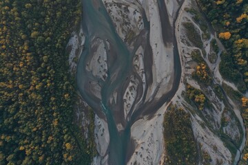 Aerial view of Laba river valley at dawn in autumn, Mostovskoy, Krasnodar Krai, Russia. Picturesque landscape, nature of Caucasus from drone. River flood, orange trees, stony coast snowy shore.