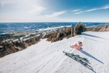 Skiing - Woman on ski taking a break looking at amazing view of winter nature landscape eating an...