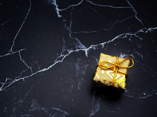 Close up gift box on black marble top view copy space