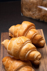 Fresh croissants on a wooden board. selective focus .bakery with copy space.