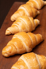 Fresh croissants on a wooden board. Fresh bakery croissants.selective focus.