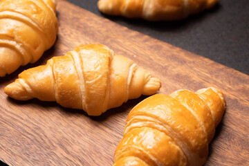 Fresh croissants on a wooden board. Fresh bakery croissants.selective focus.