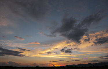 Colorful sunset and sunrise with clouds.Blue and orange color of nature.Many white clouds in the blue sky.The weather is clear today.sunset in the clouds.The sky is twilight.