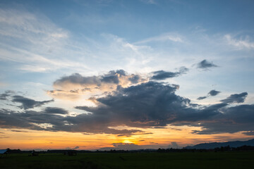 Colorful sunset and sunrise with clouds.Blue and orange color of nature.Many white clouds in the blue sky.The weather is clear today.sunset in the clouds.The sky is twilight.