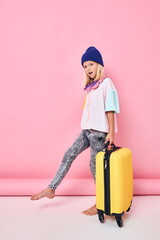 pretty girl blue hats yellow suitcases posing