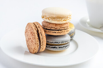 macaroons cake with a cup of coffee on a light background. close-up