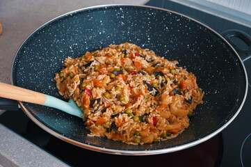 Tasty rice with vegetables prepared in wok