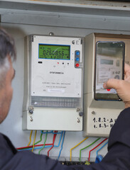 Technician Doing Meter Reading on electric cables for Kilowatt hour electric meter