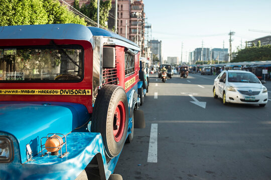 Baclaran, Paranaque, Metro Manila, Philippines - Nov 2021: A line of jeepneys is parked by the service road of Roxas boulevard.