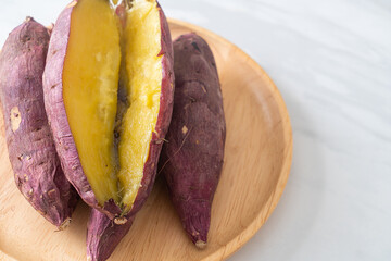 Grilled or baked Japanese sweet potatoes on wood plate