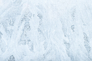 Rime pattern background. Winter weather. Low temperature. Christmas holiday. Abstract icy frost crystals texture on frozen white window pane glass surface.