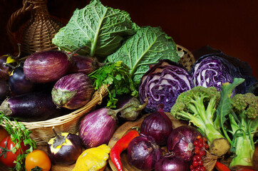 Different types of cabbage, eggplant and a bottle of wine on a brawn background.
