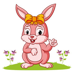 The girly rabbit is waving the hand in the garden