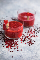 Fresh strawberry margarita or daiquiri cocktail with hearts over gray background, valentine day concepts