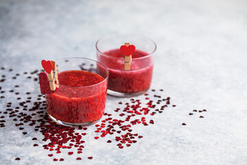 Fresh strawberry margarita or daiquiri cocktail with hearts over gray background, valentine day concepts