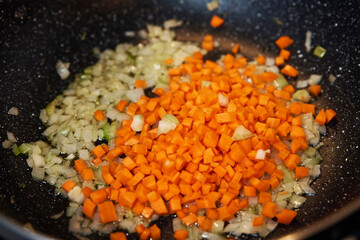 Frying vegetables for cooking sauce bolognese in kitchen