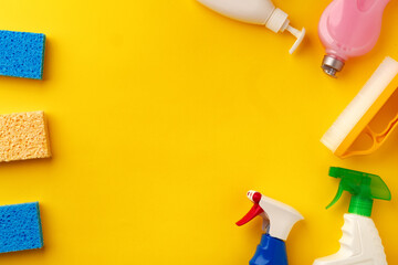 Set of cleaning supplies on yellow color background
