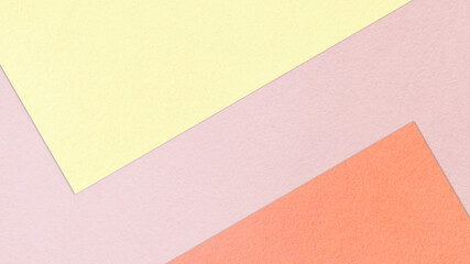 Fototapeta premium Pastel colored papers in abstract geometric pattern, top view. Yellow, pink and red colors. Abstract textured background in 4k resolution. Viewed from above. Copy space.