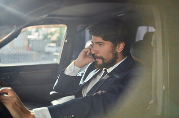 bearded man official passenger driver road communication by phone