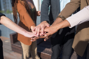 Close-up of business people putting their hands together. Stack of hands. Unity, teamwork, teambuilding concept