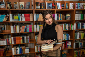 pretty brunette woman comes in her free time to read books.