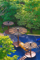 Aerial view of wooden outdoor playground equipment on blue rubber tile floor in playground area...