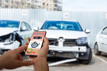 Mobile phone in hand on car repair service center blurred background