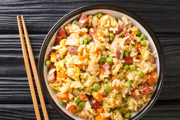 Chinese Egg Fried Rice Yang Chow Fried Rice close up in the plate on the table. Horizontal top view from above