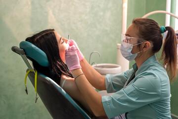   woman sitting in dentist chair on doctors review