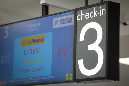 Shallow depth of field (selective focus) image with check in panels inside an airport.