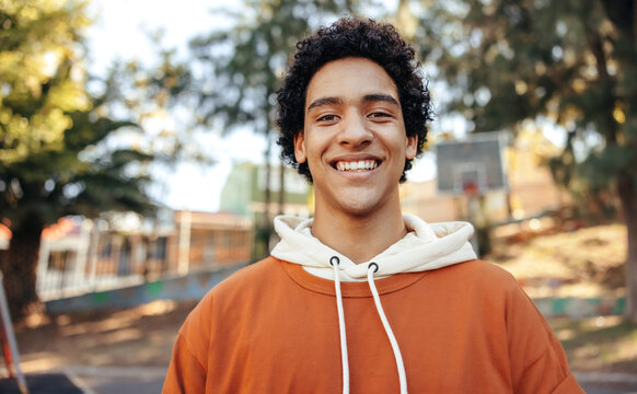 Happy male youngster smiling at the camera outdoors - Powered by Adobe