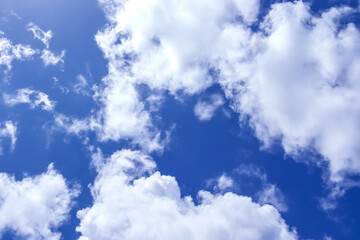 A group of white cumulus clouds in the blue sky background. The shape of the independent nature.