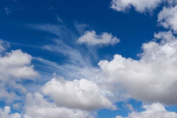 A group of white cumulus clouds in the blue sky background. The shape of the independent nature.