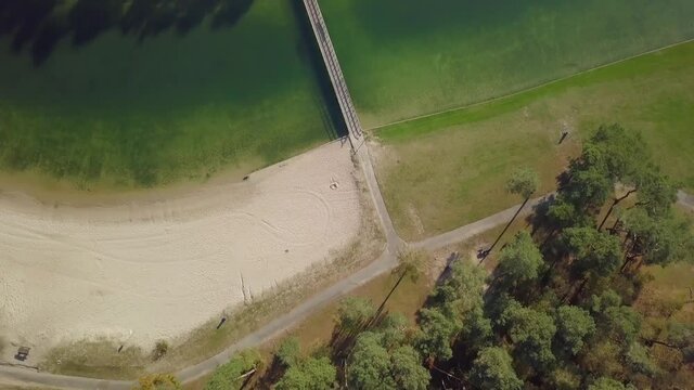 Aerial drone view of the small bridge at the recreational lake in the Netherlands, Europe.