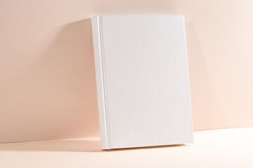 White book mockup on a beige table.