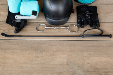 Equipment for horse care and riding with copy space for yout text: helmet, whip, gloves, bridle,...