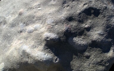 Texture of gray natural stone with shadows
