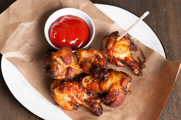 baked chicken wings together with ketchup