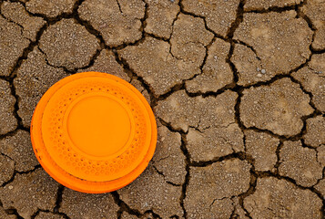Flying disk target on dried cracked soil texture background , Clay Shooting game