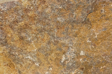 Texture of flat rough edge of gray-yellow granite stone