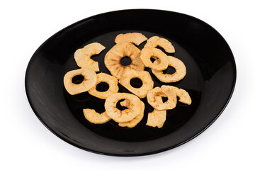 Apple chips on black dish on a white background