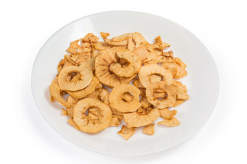 Pile of apple chips on white dish on white background