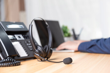 Obraz na płótnie Canvas Call center staff man hand point to press the button number on the phone office desk , Communication support, call center and customer service help desk. for (call center) concept