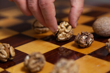 Group of walnuts lies on chessboard